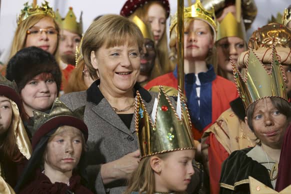 German chancellor Angela Merkel, center, attends a reception for carol singers from all over Germany at the chancellery in in Berlin, Germany.