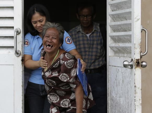 Aniolina Caimol, 63, the grandmother of shooting victim Micaela Caimol, 7, cries after viewing her grand daughter inside a morgue of a private hospital in Kawit township, Cavite province 16 kilometers (10 miles) south of Manila, Philippines.