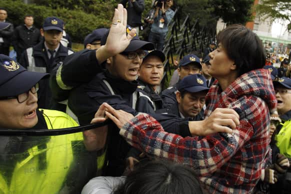 Animal rights activists scuffle with police outside of the Ministry of Agriculture over a longstanding government policy they say has led to an estimated 80,000 stray dogs being euthanized on the island each year in Taipei, Taiwan.