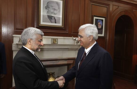 Foreign Minister Salman Khurshid, right, shakes hands with Iran’s Supreme National Security Council Secretary and chief Nuclear negotiator Saeed Jalili, in New Delhi.