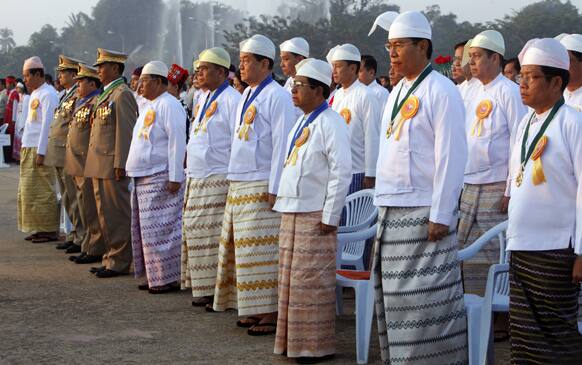 Myanmar cabinet ministers attend the national flag hoisting ceremony to mark the country`s 65th anniversary Independence Day in Naypyitaw, Myanmar.