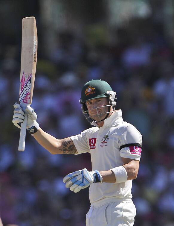 Australia`s captain Michael Clarke waves to fans after hitting a half century on day two of their third cricket test match against Sri Lanka in Sydney.