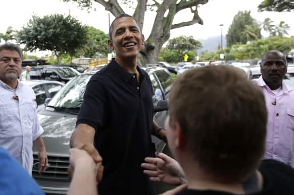 President Barack Obama greets people as he visits Island Snow for shave ice in Kailua, Hawaii, during his holiday vacation.