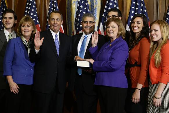 House Speaker John Boehner of Ohio performs a mock swearing in for Rep. Carol Shea-Porter, D-N.H., on Capitol Hill in Washington, as the 113th Congress began.