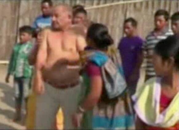 This image taken from video obtained from Network 1 News and Information Syndicate (NNIS), which has been authenticated based on its contents and other AP reporting, Bikram Singh Brahma, center, a leader of India`s ruling Congress party, is slapped by a woman in the village of Santipur.