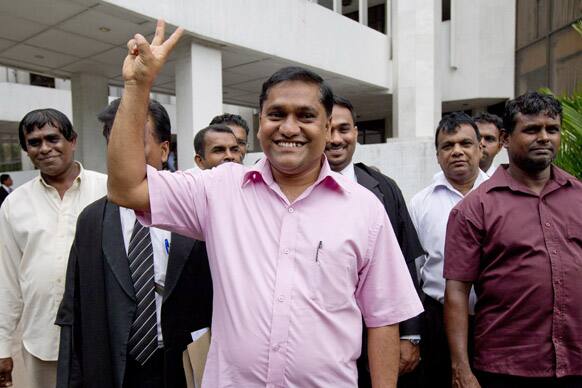 Sri Lankan opposition lawmaker Vijitha Herath displays a victory sign outside the Supreme Court after Sri Lanka`s highest court declared on Thursday that a parliament committee does not have the legal power to disqualify the country`s chief justice from office, in Colombo.