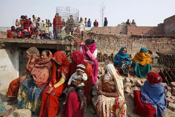 People watch a religious procession by Naga Sadhus, towards the Sangam, the confluence of rivers Ganges, Yamuna and mythical Saraswati, as part of the Mahakumbh festival in Allahabad.