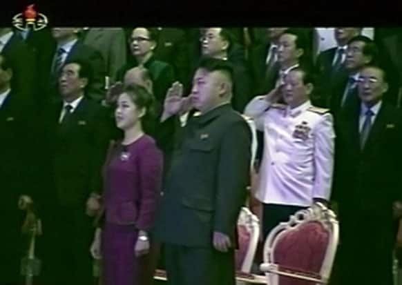 North Korean leader Kim Jong Un, center right, salutes as he and his wife Ri Sol Ju, center left, attend a New Year`s concert in Pyongyang, North Korea.