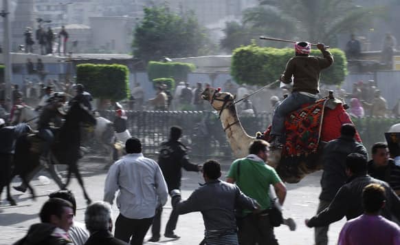 Supporters of President Hosni Mubarak, riding camels and horses, fight with anti-Mubarak protesters in Cairo, Egypt.