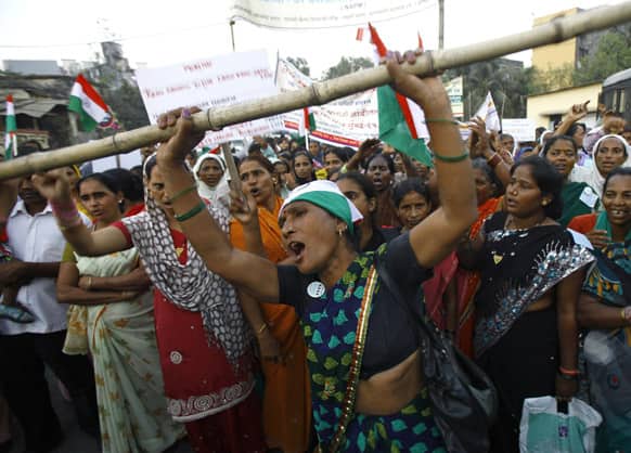 Protestors shout slogans during a march against slum evictions, land scams and other problems faced by the urban poor in Mumbai, India.