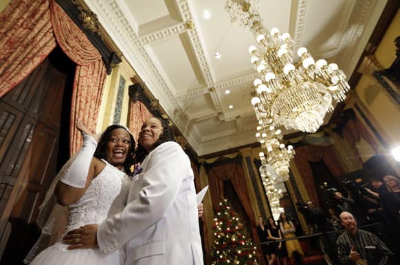 Darcia Anthony, left, and Danielle Williams react after participating in a wedding ceremony at City Hall in Baltimore, Tuesday, Jan. 1, 2013. Same-sex couples in Maryland are now legally permitted to marry under a new law that went into effect after midnight on Tuesday.