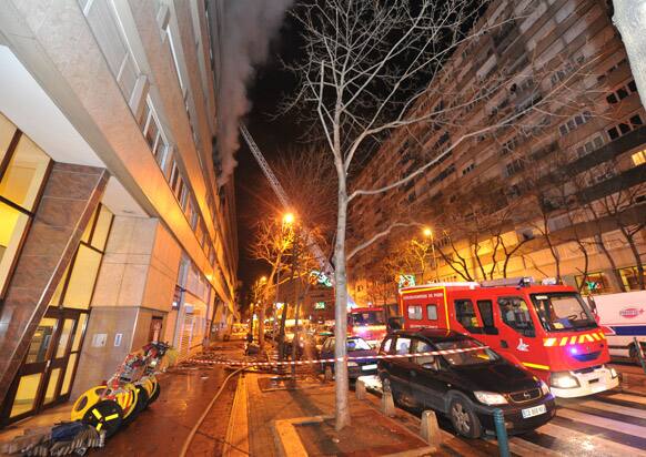 French firefighters respond to the scene of a fire in Gennevilliers, north of Paris. A fire in an apartment complex in an impoverished Paris suburb has killed five people, including two children.