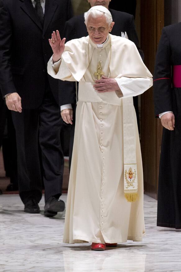 Pope Benedict XVI blesses the faithful as he arrives for his weekly general audience in the Paul IV hall at the Vatican.