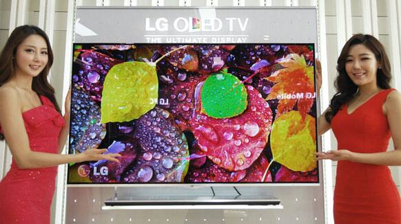 Models pose with LG Electronics` organic light-emitting diode (OLED) television in Seoul, South Korea.