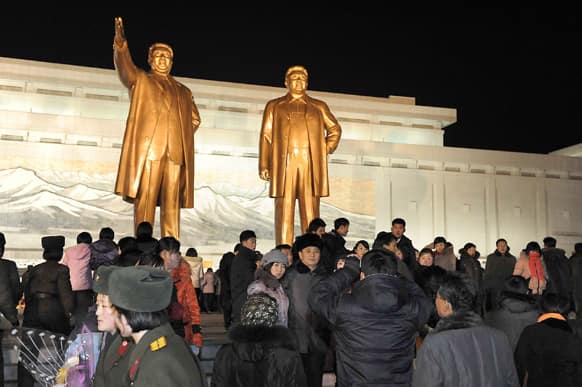 North Koreans visit giant statues of their late leaders Kim Il Sung and Kim Jong Il at Mansu Hill as they celebrate the New Year in Pyongyang, North Korea.