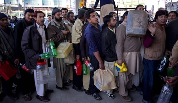 People queue at a gas station to get fuel in Rawalpindi. After severe shortage of Compressed Natural Gas (CNG) used in cars, now consumers are also facing shortage of gasoline.