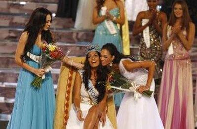 Miss Gibraltar Kaiane Aldorino (C) is congratulated by South Africa's Tatum Keshwar (R), who was crowned second princess, and Miss Mexico Perla Beltran, who was was crowned first princess