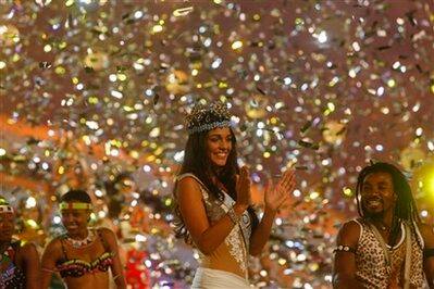 Miss World, Gibraltar's Kaiane Aldorino, center, claps hands after she was crowned during the Miss World pageant in Johannesburg, South Africa, Saturday, Dec. 12, 2009