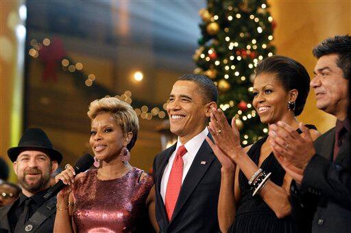 Sugarland's Kristian Bush, left, Mary J Blige, President Barack Obama and first lady Michelle Obama and George Lopez applaud during Christmas at the National Building Museum in Washington