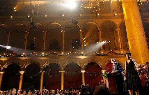 President Barack Obama speaks as he and first lady Michelle Obama attend Christmas at the National Building Museum in Washington