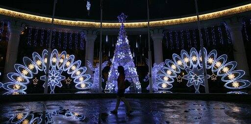 A pedestrian walks past the Christmas decorations on display for the upcoming Christmas celebration in Petaling Jaya, near Kuala Lumpur, Malaysia