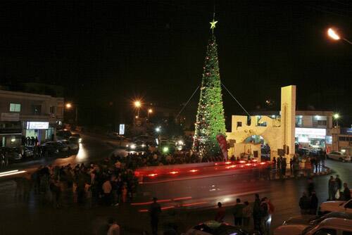 Jordanians gather to celebrate the lighting of a 26-metre tall Christmas tree in the Christian town of Al-Fuheis near Amman.