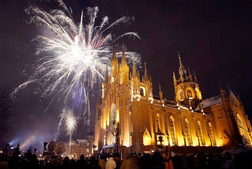 People celebrate Christmas Eve in front of Moscow's Catholic Church of the Immaculate Conception, Russia.