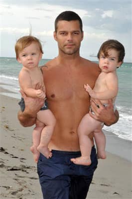 In this August 2009 family photo provided courtesy of Ricky Martin, singer and actor Ricky martin poses with his twin sons Matteo, left, and Valentino in Miami. 