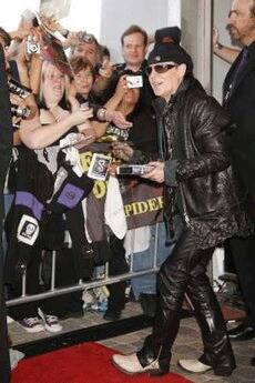 Scorpions band member Klaus Meine signs autographs as the band is inducted into the Hollywood RockWalk in Hollywood, California.