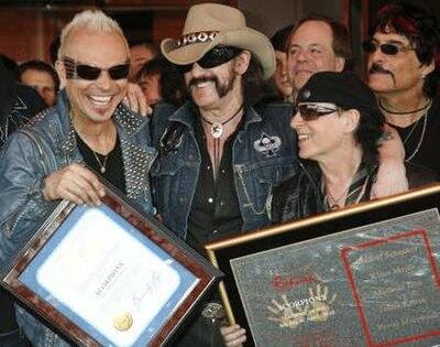 Lemmy Kilmister (2nd L) of the band Motorhead celebrates with Scorpions band members Rudolf Schenker (L) and Klaus Meine (R) as the Scorpions are inducted into the Hollywood RockWalk in Hollywood, Cal