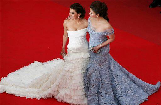 Actress Aishwarya Rai, right, and actress Eva Longoria, left, arrive on the red carpet for the premiere for the film robin Hood, at the 63rd international film festival, in Cannes, southern France,