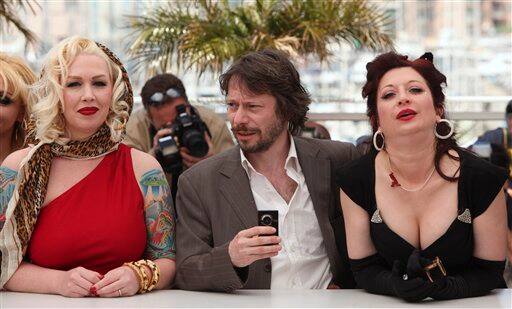 actress Mimi Le Meaux, left, actor and director Mathieu Amalric, center, and actress Dirty Martini, right, pose during a photo call for Tournee, at the 63rd international film festival, in Cannes.