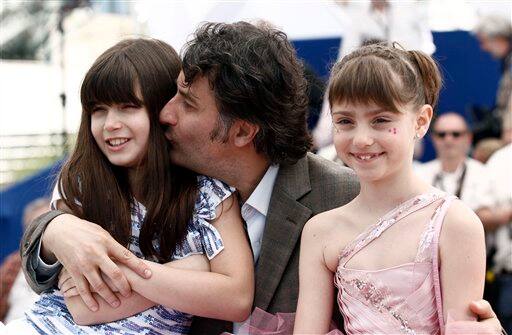 From left, actress Ileana Puiu, director and actor Cristi Puiu and actress Carmela Culda pose for photographers during a photo call for 