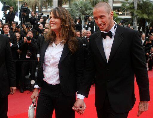 Retired Olympic swimmer Laure Manaudou, left, and swimmer Frederick Bousquet, right, arrive for the premiere of 