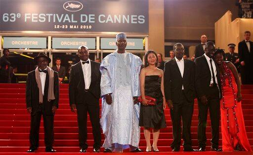 From left, actor Marius Yelolo, actor Emil Abossolo, actor Youssouf Djaoro, actress Heling Li, director Mahamat-Saleh Haroun, actor Diouc Koma, and actor Djeneba Kone arrive for the screening of 