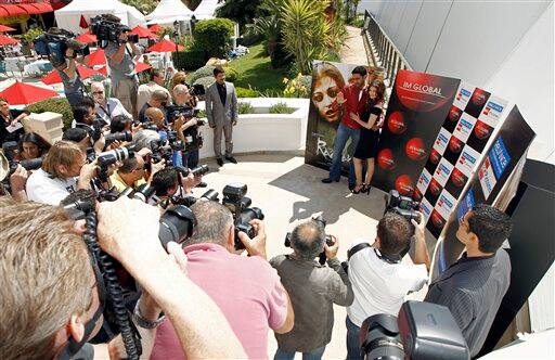 Actor Abhishek Bachchanm, left, and actress Aishwarya Rai pose during a photo call for 