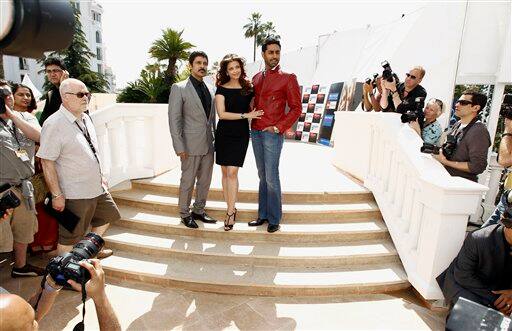 From left, actor Vikram, actress Aishwarya Rai and Abhishek Bachchan pose during a photo call for 