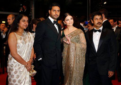 Actress Aishwarya Rai, center right, and actor Abhishek Bachchan, center left, and unidentified guests arrive for the screening of 