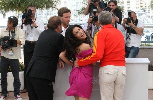 From left, director Xavier Beauvois, actress Sabrina Quazani and actor Lambert Wilson pose during a photo call for the film 