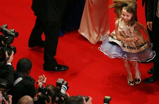 Actress Faith Wladyka dances for photographers as she arrives for the screening of 