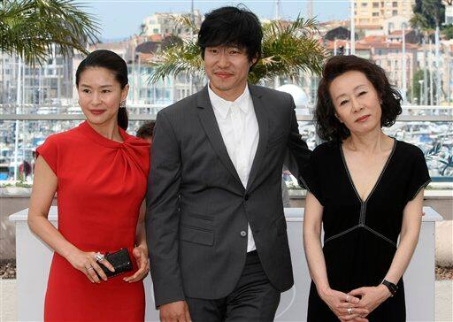 Actress Ye Jiwon, left, actor Yu Joonsang, center, and actress Youn Yuh-jung, right, pose during a photo call for 