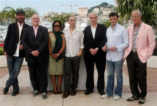 Producer Michael Weber, producer Keith Griffith, actress Wallapa Mongkolprasert, director Apichatpong Weerasethakul, producer Simon Field, producer Charles de Meaux, and producer Luis Minarro pose during a photo call for Uncle Boonmee Who Can Recall His Past Lives.