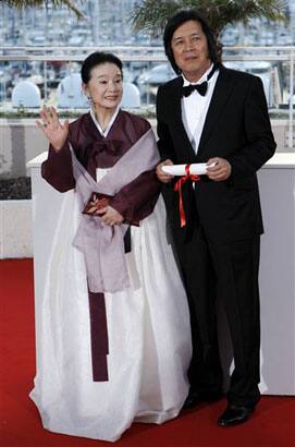 Winner of the award for Best Screenplay director Lee Changdong, right, and actress Yun Junghee posesafter the awards ceremony at the 63rd international film festival, in Cannes