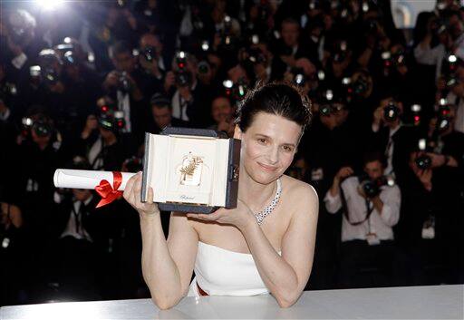 Actress Juliette Binoche poses for photographers with her Best Actress award, during a photo call following the awards ceremony at the 63rd international film festival, in Cannes