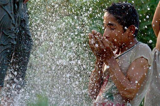 A Pakistani cools off with water as temperature reached up to 44 degrees Celsius in Islamabad.