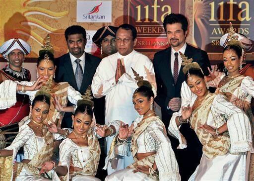 Anil Kapoor, Muttiah Muralitharan, Lakshman Yapa Abeywardena, pose along with Sri Lankan dancers at an event to announce the IIFA awards, in New Delhi, India