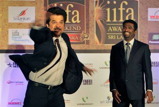 Anil Kapoor, mimics the bowling action of Muttiah Muralitharan, at an event to announce the International Indian Film Academy (IIFA) awards, in New Delhi, India