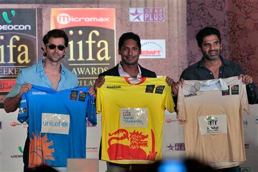 Hrithik Roshan, Sunil Shetty, and Sri Lankan cricket team captain Kumar Sangakkara, pose for photographs holding cricket jerseys to promote the International Indian Film Association (IIFA) awards