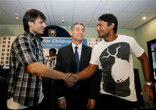 Sri Lankan cricket captain Kumar Sangakkara, right, shakes hands with Bollywood actor Vivek Oberoi, left , as UNICEF country representative Philippe Duamelle, center, looks on during a press conference held to announce a celebrity cricket match promoting Indian International Film Academy awards 