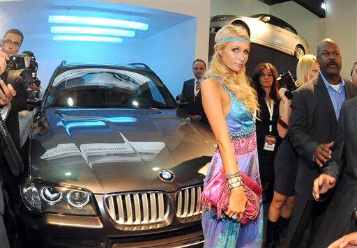 American heiress Paris Hilton poses in front of a new BMW model at a car show in Cairo, Egypt. 